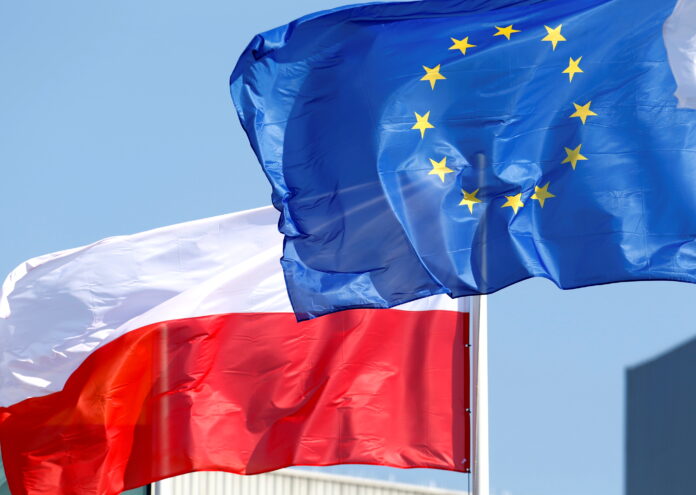 FILE PHOTO: EU and Polish flags flutter at the Orlen refinery in Mazeikiai
